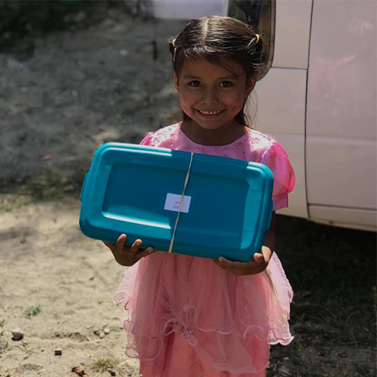 loving-with-mercy-christmas-boxes-smiling-girl-with-gift-container