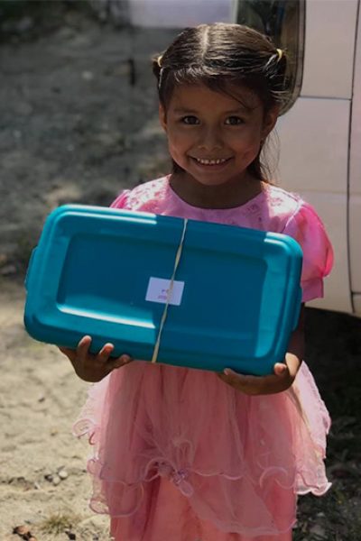 loving-with-mercy-christmas-boxes-smiling-girl-with-gift-container