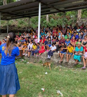 loving-with-mercy-el-salvador-community-female-volunteer-preaching-to-large-group-2